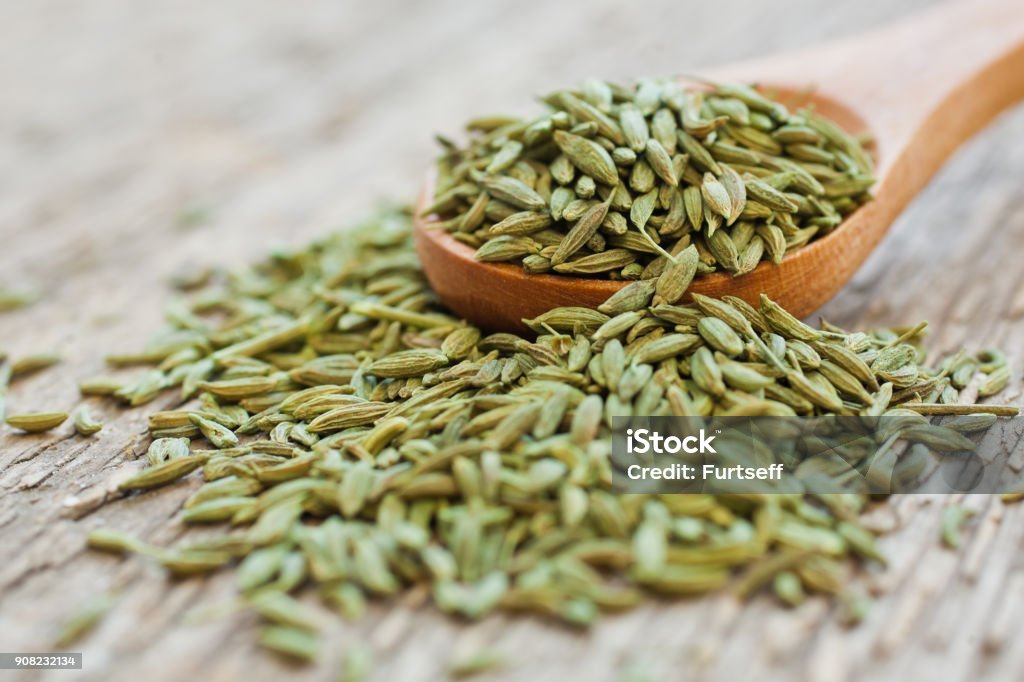 Green anise closeup Green anise in a wooden spoon closeup Fennel Stock Photo