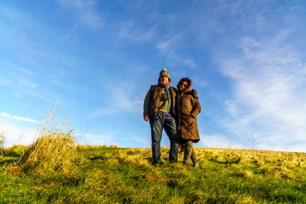 istock Senior couple walking on countryside path in winter 908234440