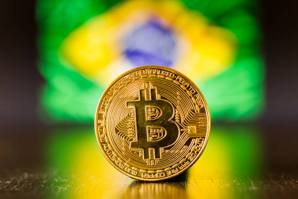Golden bitcoin coin on Brazil flag as background stock photo