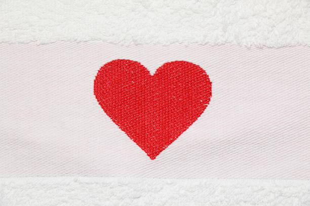 Embroidered red heart on a white background Embroidered red heart on a white background close-up terry towel stock pictures, royalty-free photos & images