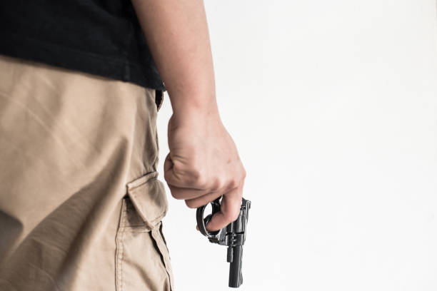 istock Hand shooting gun on white background killer concept. 908241412