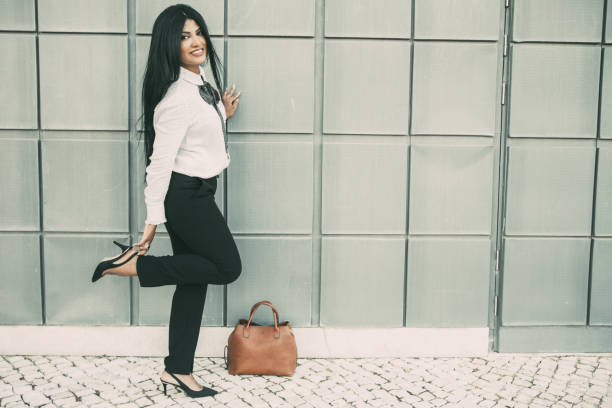 Playful businesswoman enjoying stroll after work