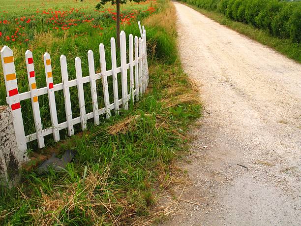 Fence along grassy field in rural landscape.