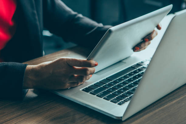 istock Businesswoman working with laptop and touchpad 908244204