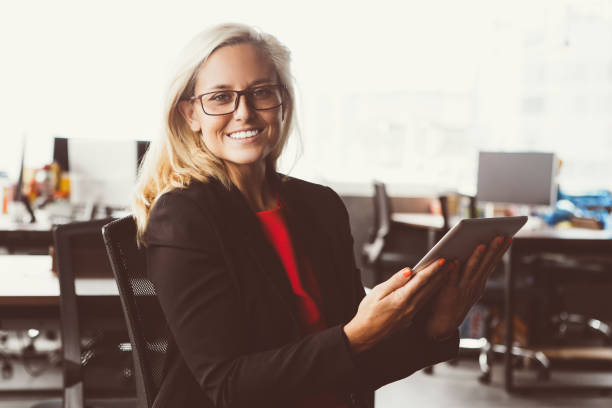 istock Cheerful businesswoman holding digital tablet 908244206