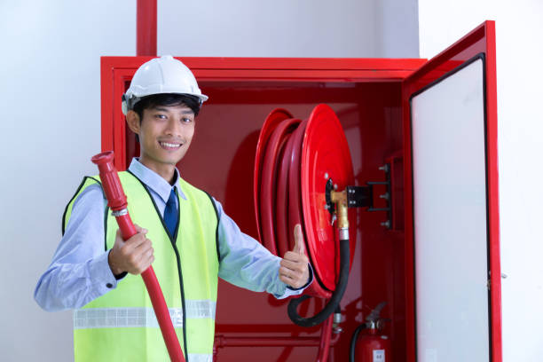 istock Male Professional checking a fire extinguisher. 908244850