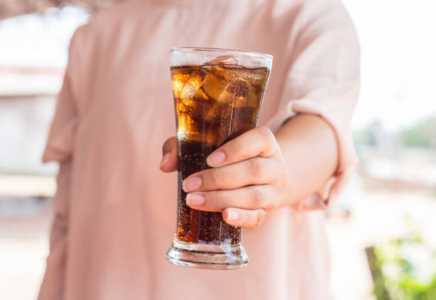 istock glass of cola with ice. 908244918