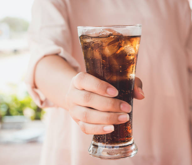 istock glass of cola with ice. 908244922