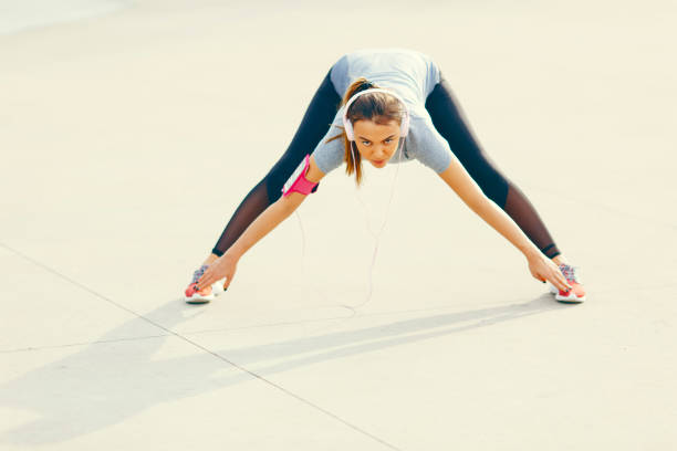 istock Young woman having exercise outdoors 908248560