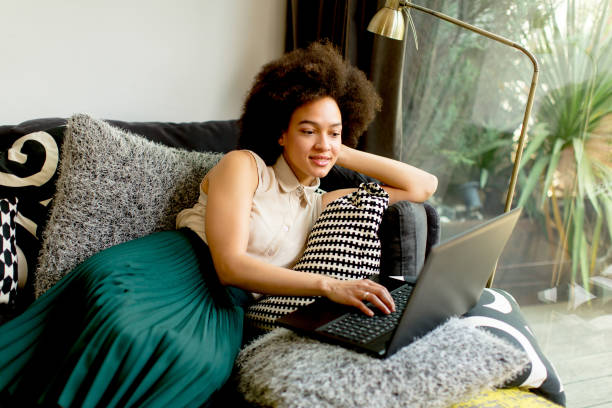 istock Young african american woman web-surfing internet 908252016