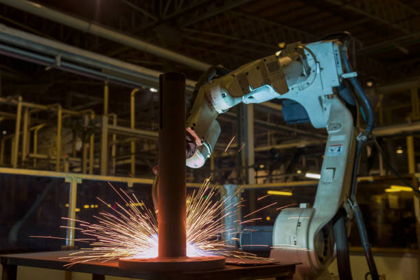 istock Industrial robot is welding in car factory 908255480