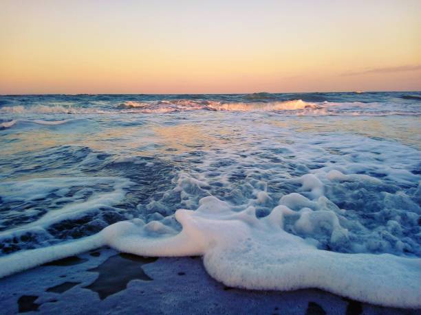 istock Wave and sunset at the sea. 908256012