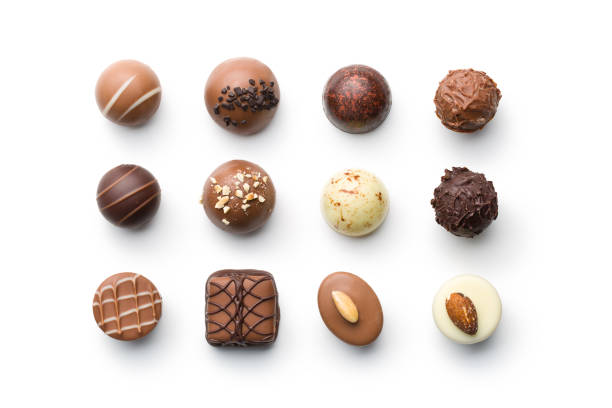 various chocolate pralines top view of various chocolate pralines on white background belgian culture photos stock pictures, royalty-free photos & images