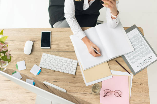 istock businesswoman doing paperwork at workplace 908260378