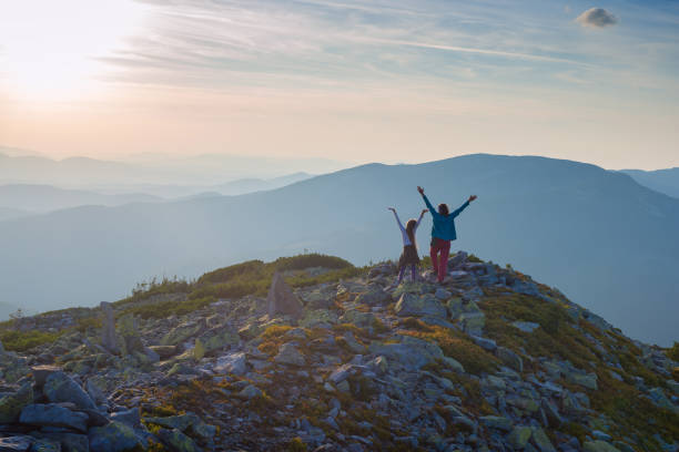 istock Mom and daughter enjoying  sunset 908263954