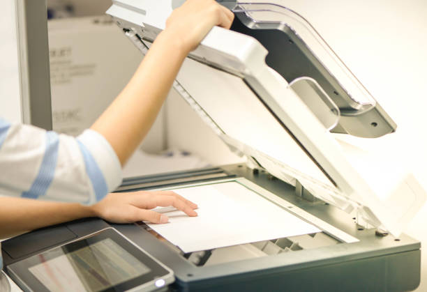 istock Business woman is using the printer to scanning the document 908267184