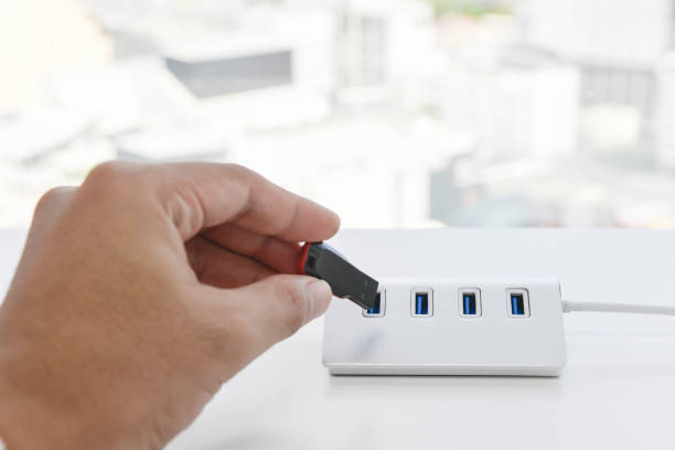 istock Human hand is putting the USB drive to USB hub 908267288