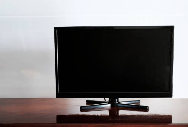 istock black television on wooden table white background 908270624
