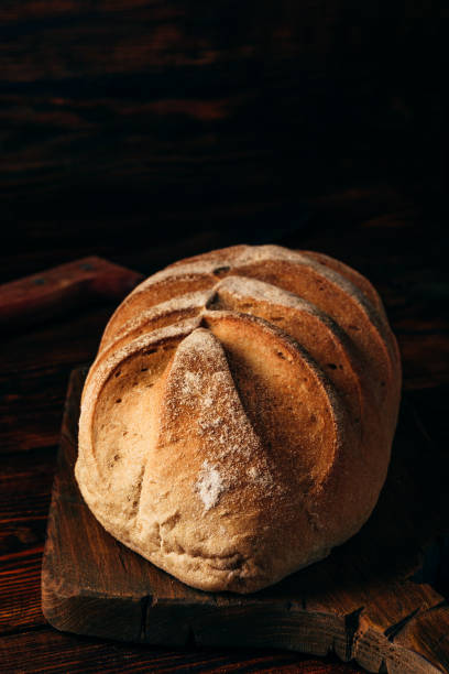 istock Rye loaf on cutting board with knife. 908270892