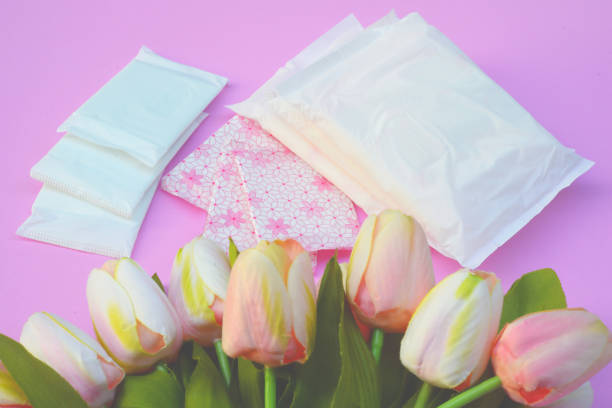 Sanitary napkins, pad (sanitary towel, sanitary pad, menstrual pad) on pink background. stock photo