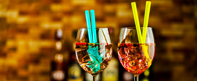 Tasty and colorful drinks based on various alcohols, syrups, and liqueurs, unique effect of the bartender's work, party night