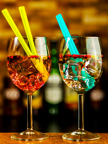 Tasty and colorful drinks based on various alcohols, syrups, and liqueurs, unique effect of the bartender's work, party night