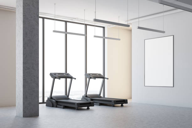 istock Two treadmills in a white room corner, poster 908279064