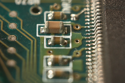 detail of some electrical micro-resistors mounted on a printed board.