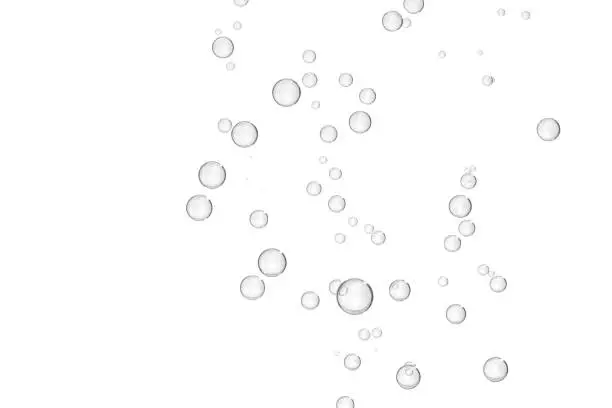 Gray fizz bubbles isolated over a white background.