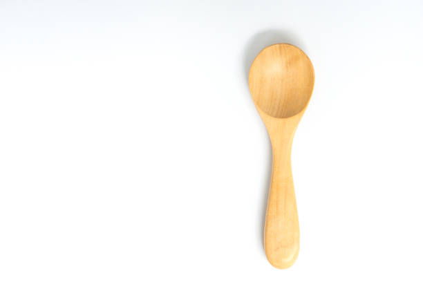 istock Wooden spoon on the white screen isolated 908290390