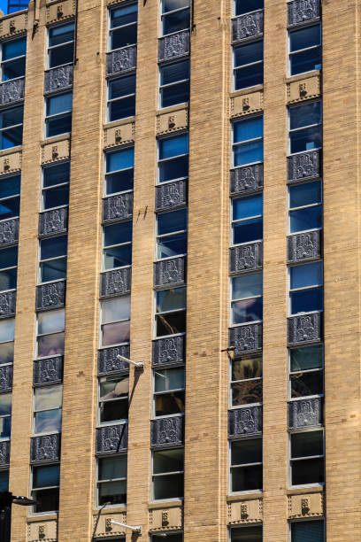 istock Old Brown Brick Building with Black Iron Panels 908293362
