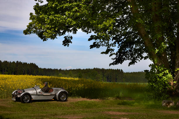istock Old vintage open top car on the country road 908295152