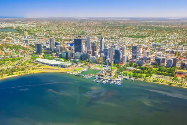 Aerial view of Perth Skyline in Australia. Scenic flight over Elizabeth Quay, Bell Tower, Elizabeth Quay Bridge, Swan River, Perth Convention and Exhibition Center in Western Australia. Copy space.