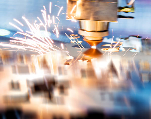 istock Laser cutting metal sheet with sparks flying 908300838