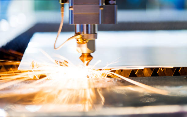 istock Laser cutting metal sheet with sparks flying 908301052