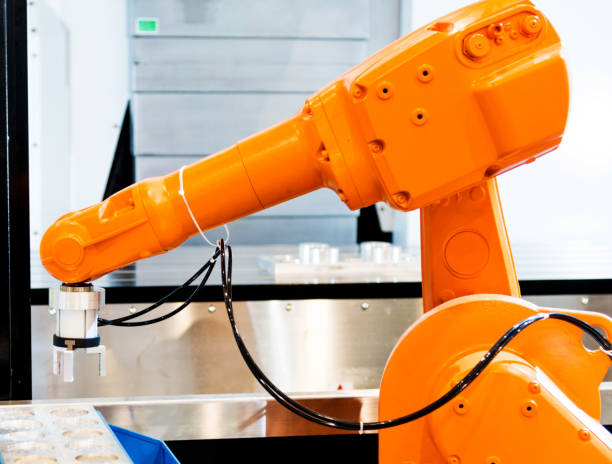 istock Robot arm working in a factory 908301530