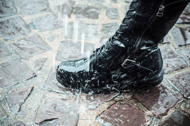 istock leather boot in the rain on the cobblestone 908303870