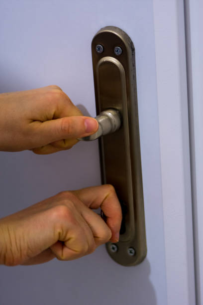 istock Woman locking the door 908303936