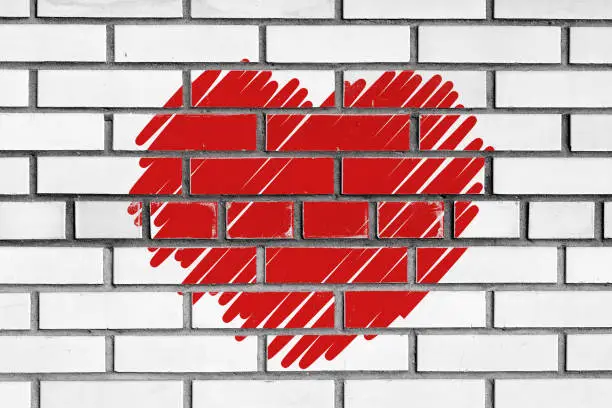 sketched red heart over white bricks wall