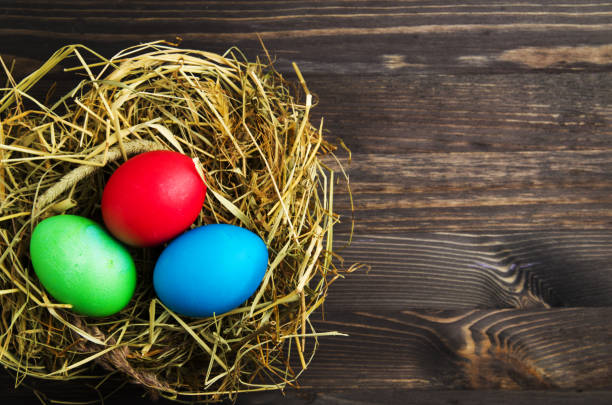 istock Easter eggs on a wooden background .Easter eggs of different colors .Easter eggs top view 908304406
