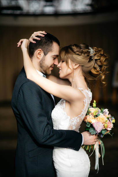 istock Young and beautiful bride and groom embrace 908307088