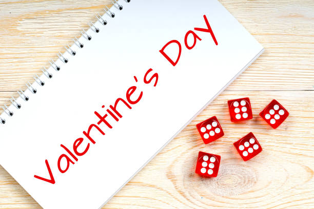 istock valentine's day text on wooden table with red dices 908307652