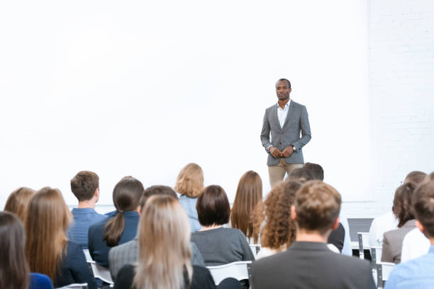 istock african man standing against copy space at meeting 908313980