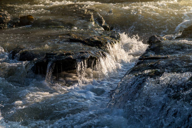 istock View of the water in the fast river at sunset 908314296