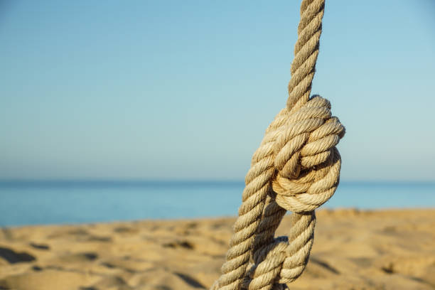 Boat ropes and footprint on sandy beach background .