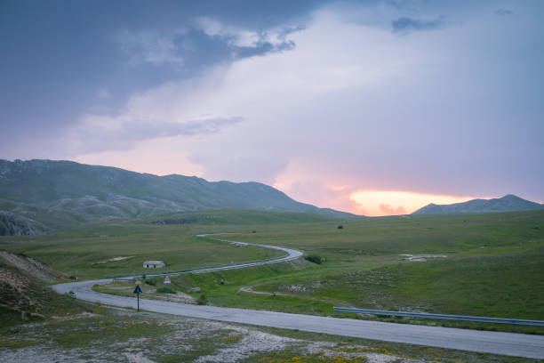 istock Twisting mountain road at sunset. Italy. 908330418