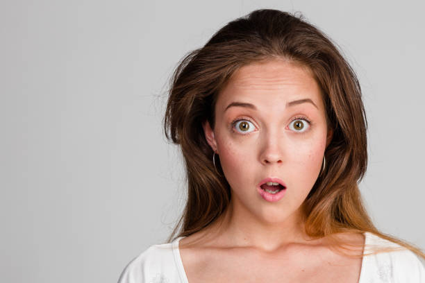 istock portrait of  surprised brunette with big eyes 908340830