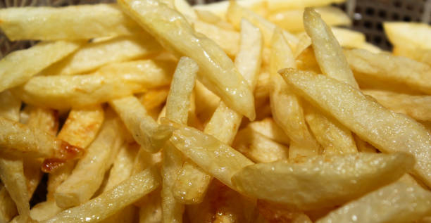 istock Yummy french fries as background. potato chips 908344236