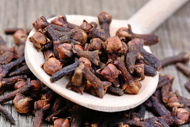 istock Cloves in a wooden spoon on table 908347480