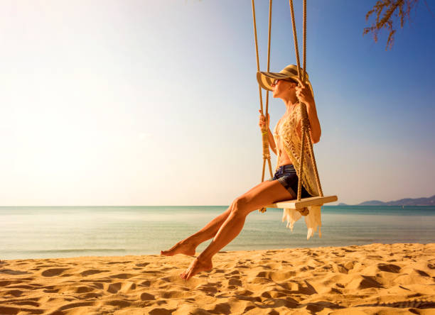 istock Woman at tropical swing 908347596
